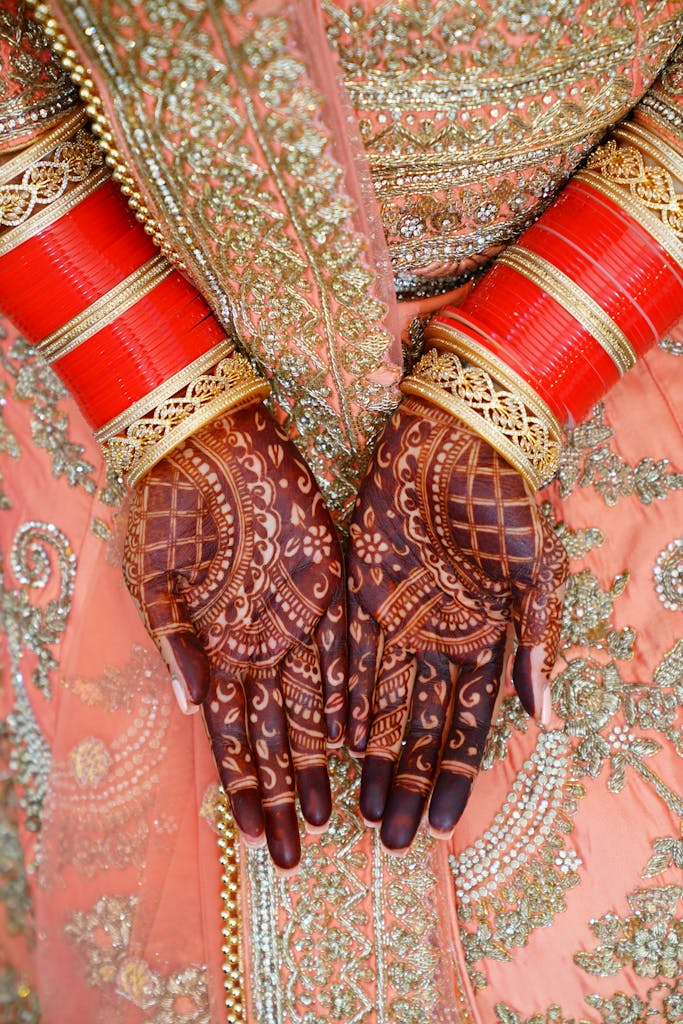 Close-up of bride's hands with Indian mehndi, showcasing Indian bridal tradition.